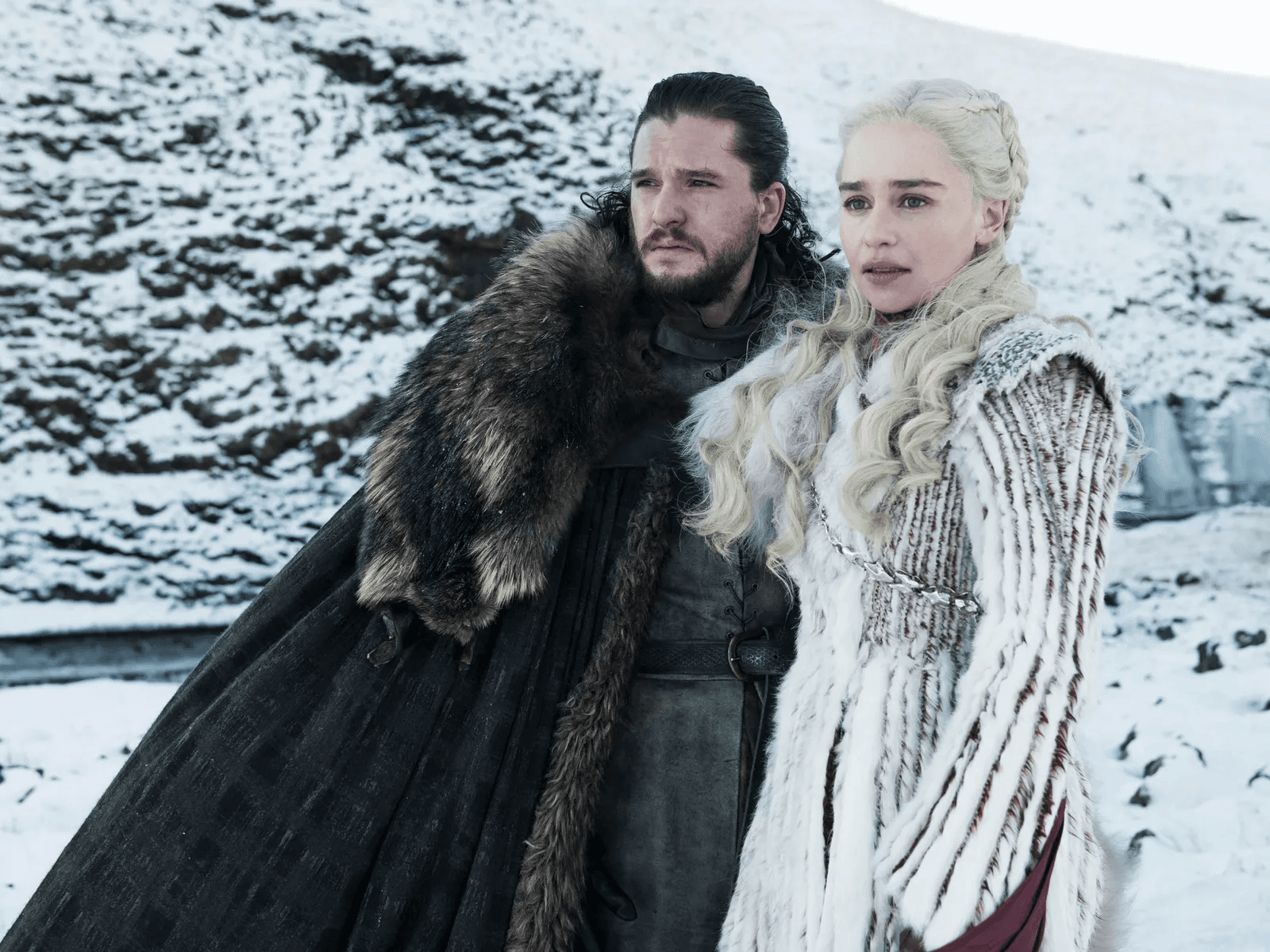 Jon Snow and Daenerys standing in the snow covered background