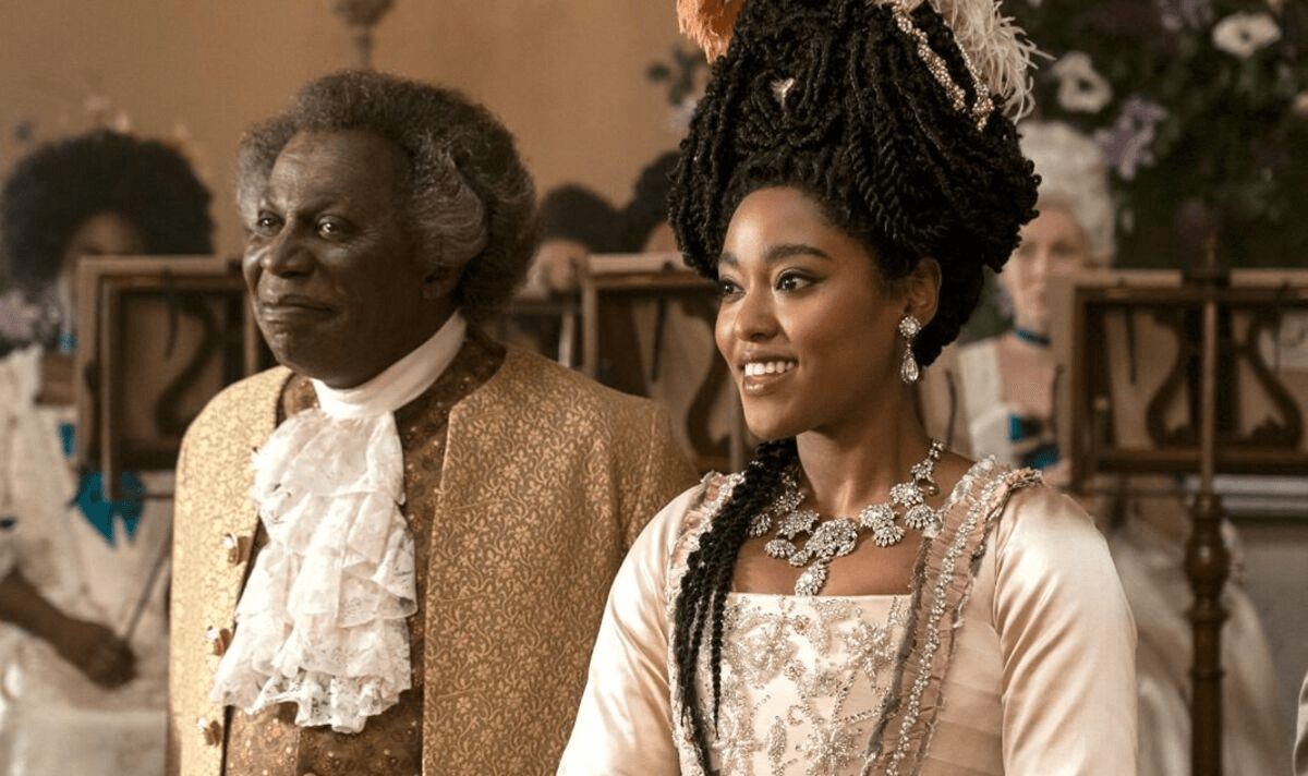 Lord and Lady Danbury sitting and smiling