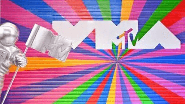 An astronaut holding an MTV flag