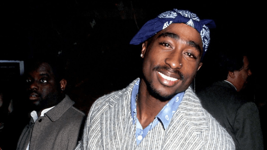 Tupac Shakur smiling into the camera